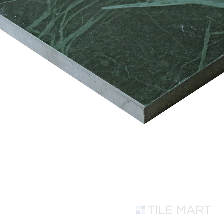 Diagonal view of Tele Di Marmo Revolution Verde St Denis 24x48 polished porcelain tile, highlighting its deep green hues, natural veining, and reflective polished finish.  