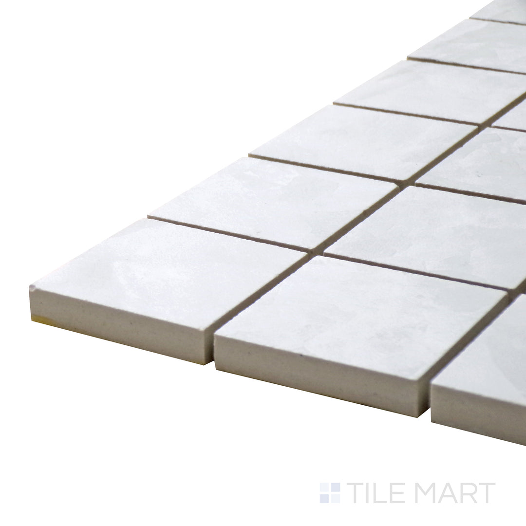 Corner-focused shot of Tele Di Marmo Revolution Thassos 2" Square Matte Porcelain Mosaic, highlighting its bright white marble look with a refined matte texture.