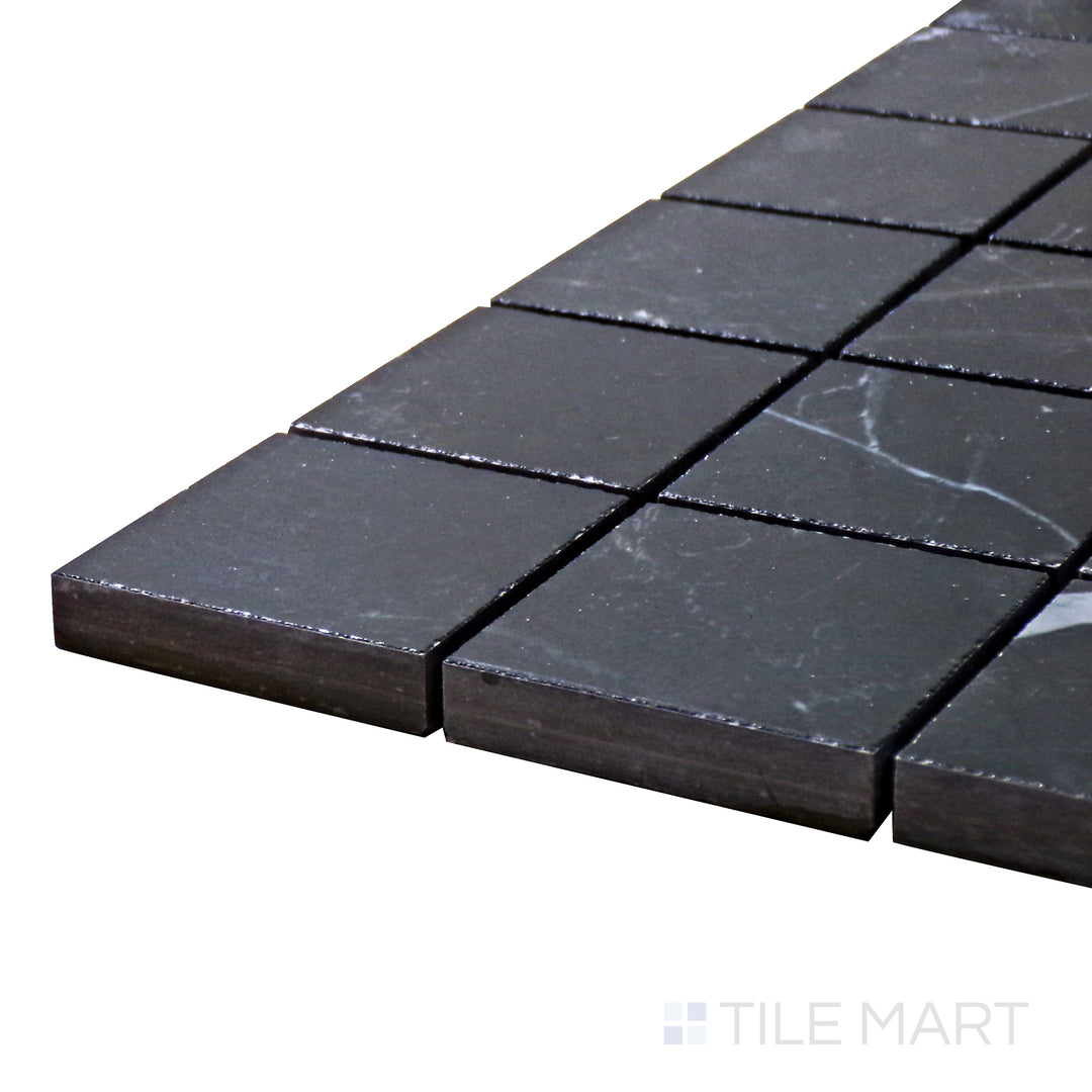 Corner angle of Tele Di Marmo Revolution Calacatta Black 2" Square Polished Porcelain Mosaic, emphasizing its bold black marble aesthetic with crisp white veining in a polished format.