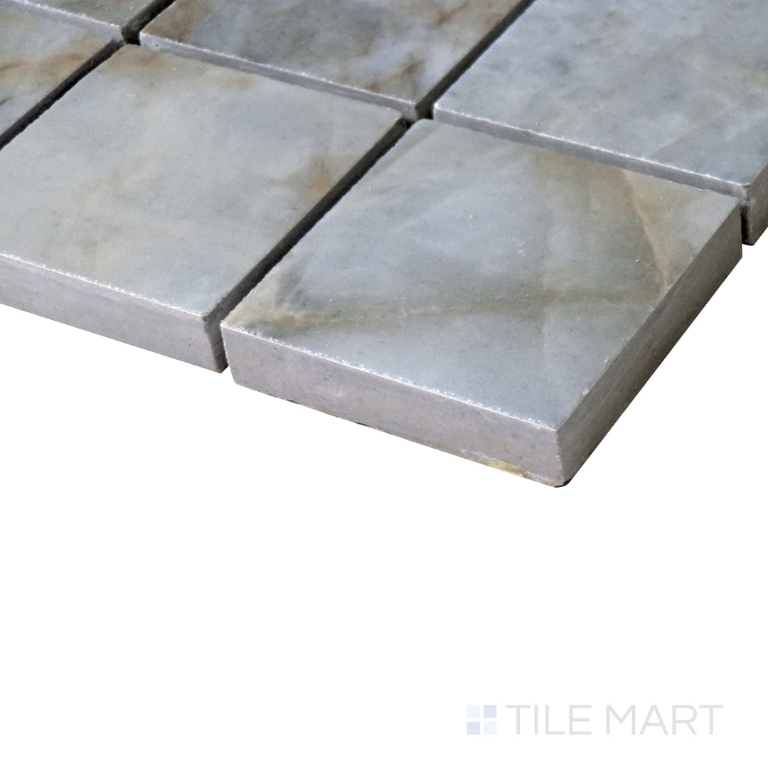 Slanted angle of Tele Di Marmo Revolution Patagonia 2" Square polished porcelain mosaic, showcasing its vibrant color palette, intricate veining, and reflective polished surface.  