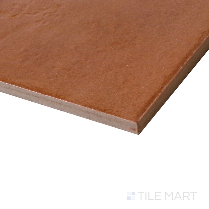 Diagonal view of Terracotta Italian Saltillo Terra Cotta 13x13 polished porcelain tile, highlighting its classic terracotta hues, smooth texture, and reflective polished finish.  