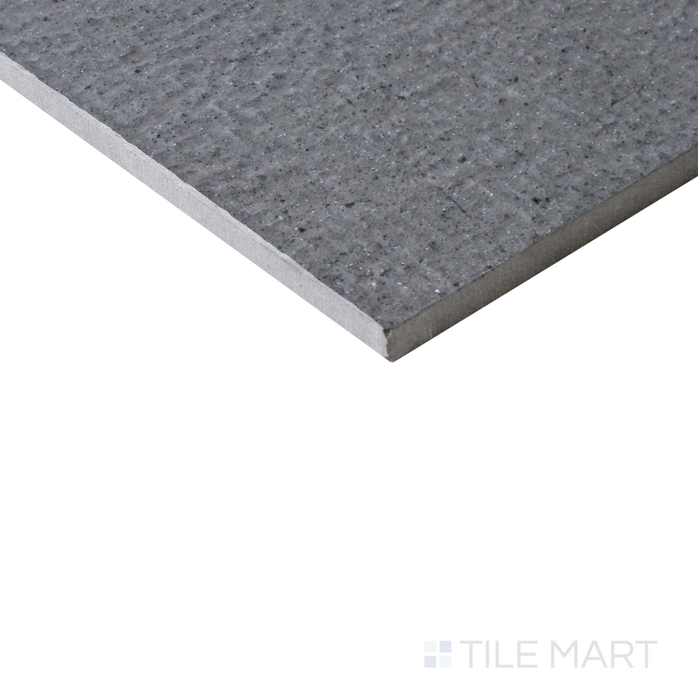 Slanted angle of Urban Living Titanium 12x24 chiseled porcelain tile, capturing its cool titanium gray hues, rough-cut edges, and natural stone-like appeal.  