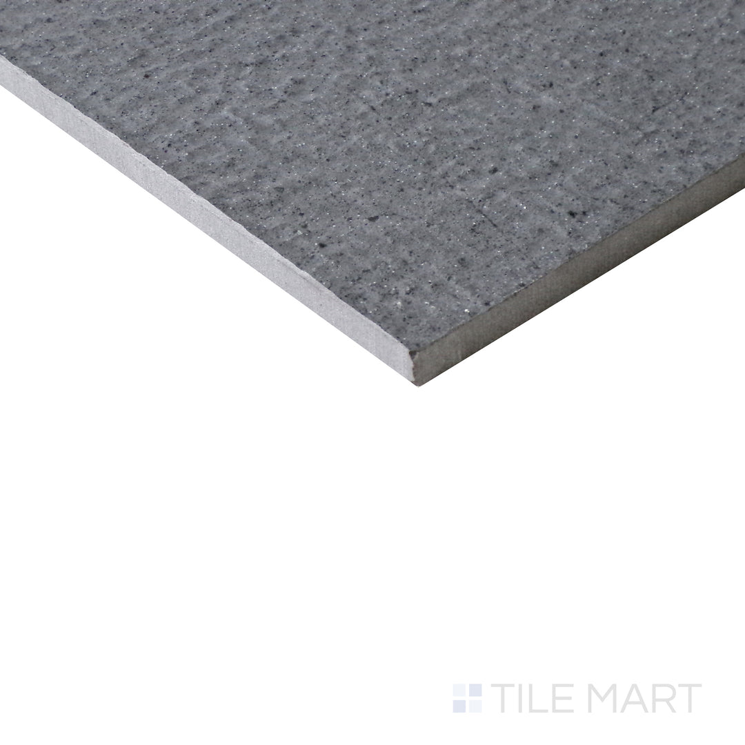 Slanted angle of Urban Living Titanium 12x24 chiseled porcelain tile, capturing its cool titanium gray hues, rough-cut edges, and natural stone-like appeal.  