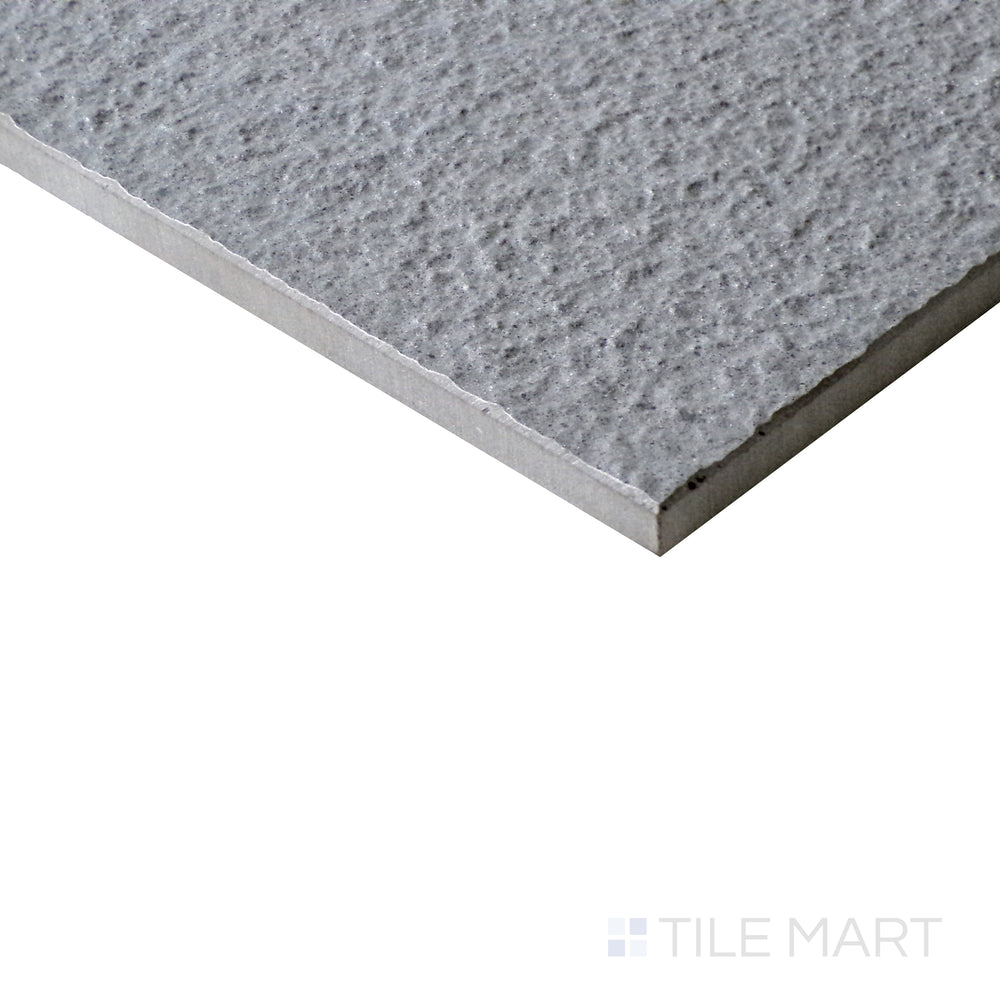 Slanted perspective of Urban Living Mist Grey 12x24 raw porcelain tile, emphasizing its soft gray color, natural raw texture, and minimalist aesthetic.  