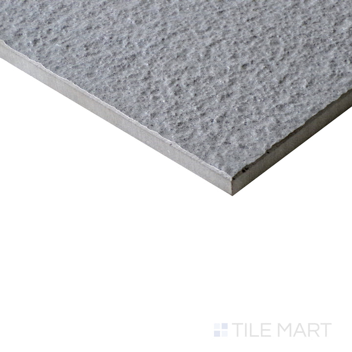 Slanted perspective of Urban Living Mist Grey 12x24 raw porcelain tile, emphasizing its soft gray color, natural raw texture, and minimalist aesthetic.  