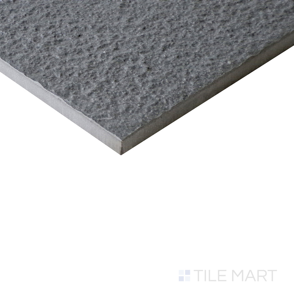 Slanted angle of Urban Living Titanium 12x24 raw porcelain tile, capturing its sleek titanium gray finish, rugged raw surface, and urban-inspired appeal.  