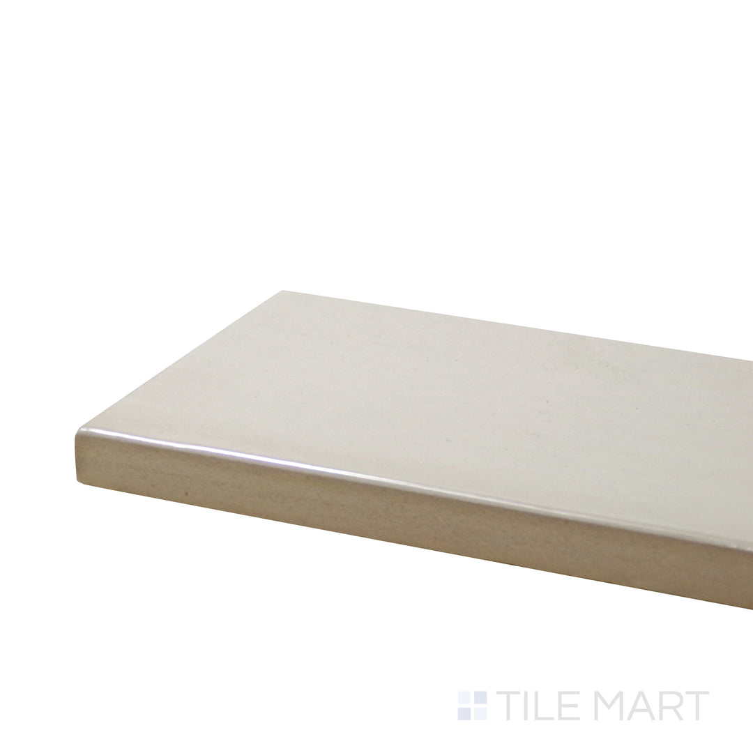 Corner shot of Village Mushroom 2.5X8 Glossy Ceramic Tile, showcasing its warm earthy tones with a smooth, reflective surface.