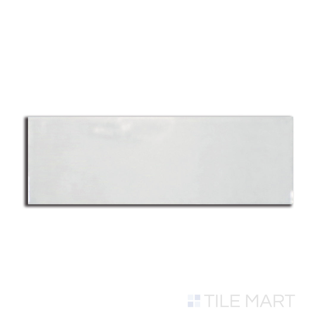 Flat-lay image of Village Silver Mist 2.5X8 glossy ceramic tile, offering a soft gray hue with a pearlescent shine that enhances modern interiors.
