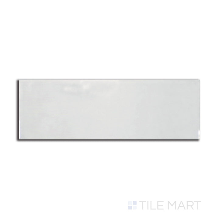 Flat-lay image of Village Silver Mist 2.5X8 glossy ceramic tile, offering a soft gray hue with a pearlescent shine that enhances modern interiors.
