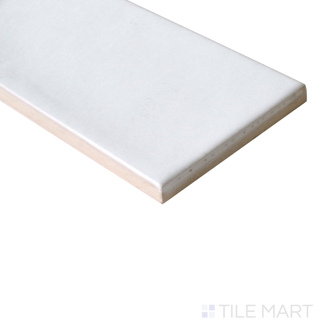 Slanted perspective of Village White 2.5x8 glossy ceramic tile, emphasizing its crisp white color, reflective surface, and modern rectangular format.  