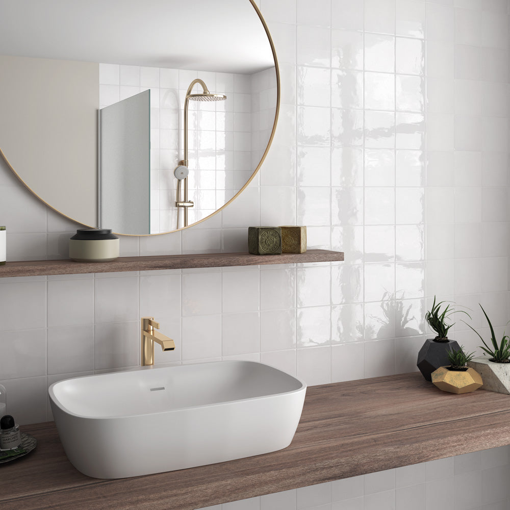 A timeless and airy interior complemented by Village White 2.5X8 Glossy Ceramic, bringing a clean, minimalist aesthetic with a polished and luminous effect.