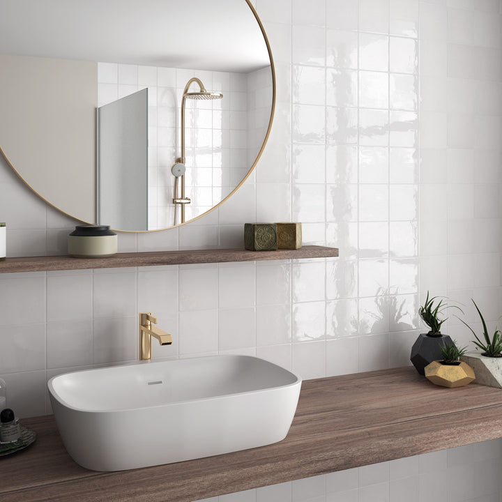 A timeless and airy interior complemented by Village White 2.5X8 Glossy Ceramic, bringing a clean, minimalist aesthetic with a polished and luminous effect.