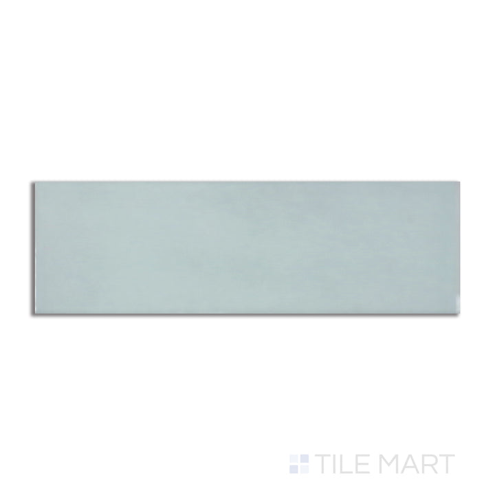 Flat-lay image of Village Mint 2.5X8 glossy ceramic tile, capturing a pastel green shade with a bright, reflective surface for a fresh aesthetic.
