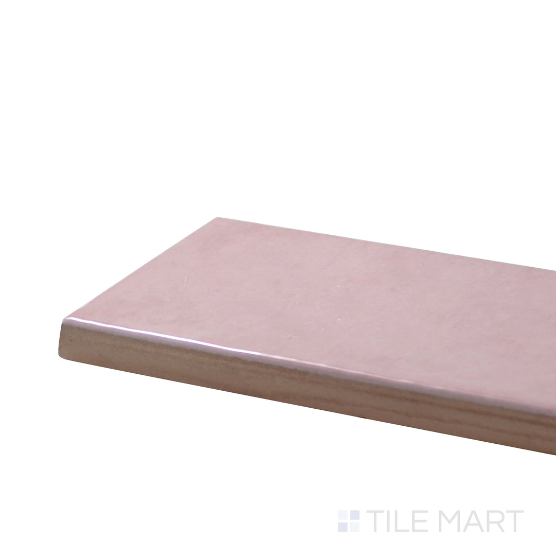 Close-up corner shot of Village Rose Gold 2.5X8 Glossy Ceramic Tile, featuring its soft pink-gold hue with a shimmering, high-gloss surface.