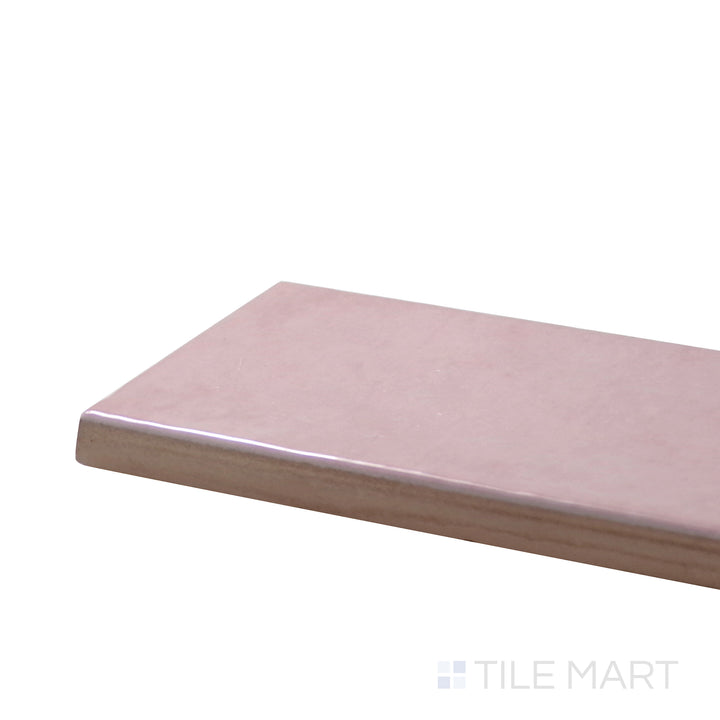 Close-up corner shot of Village Rose Gold 2.5X8 Glossy Ceramic Tile, featuring its soft pink-gold hue with a shimmering, high-gloss surface.