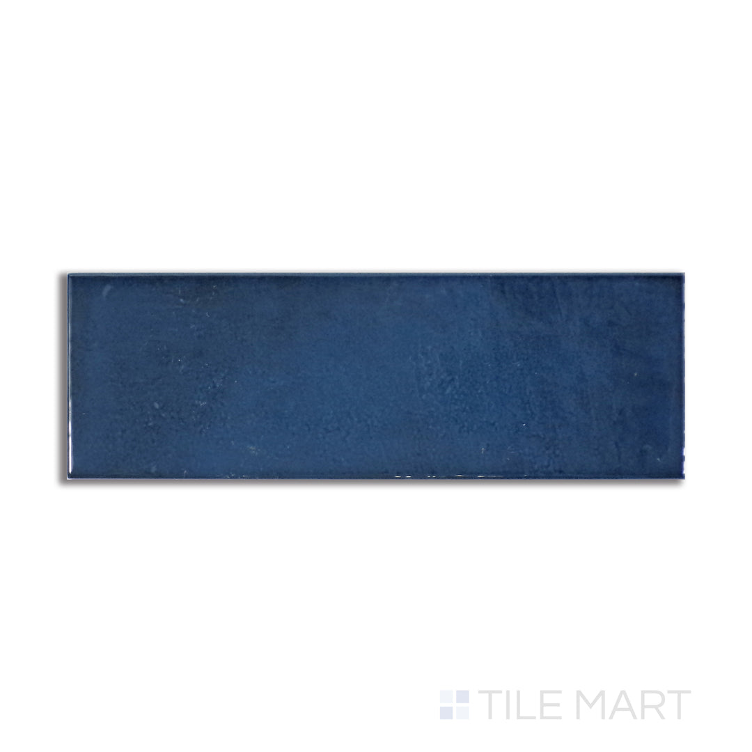 Top-down view of Village Royal Blue 2.5X8 glossy ceramic tile, boasting a rich blue hue with a sleek, glossy texture that adds depth and vibrance.