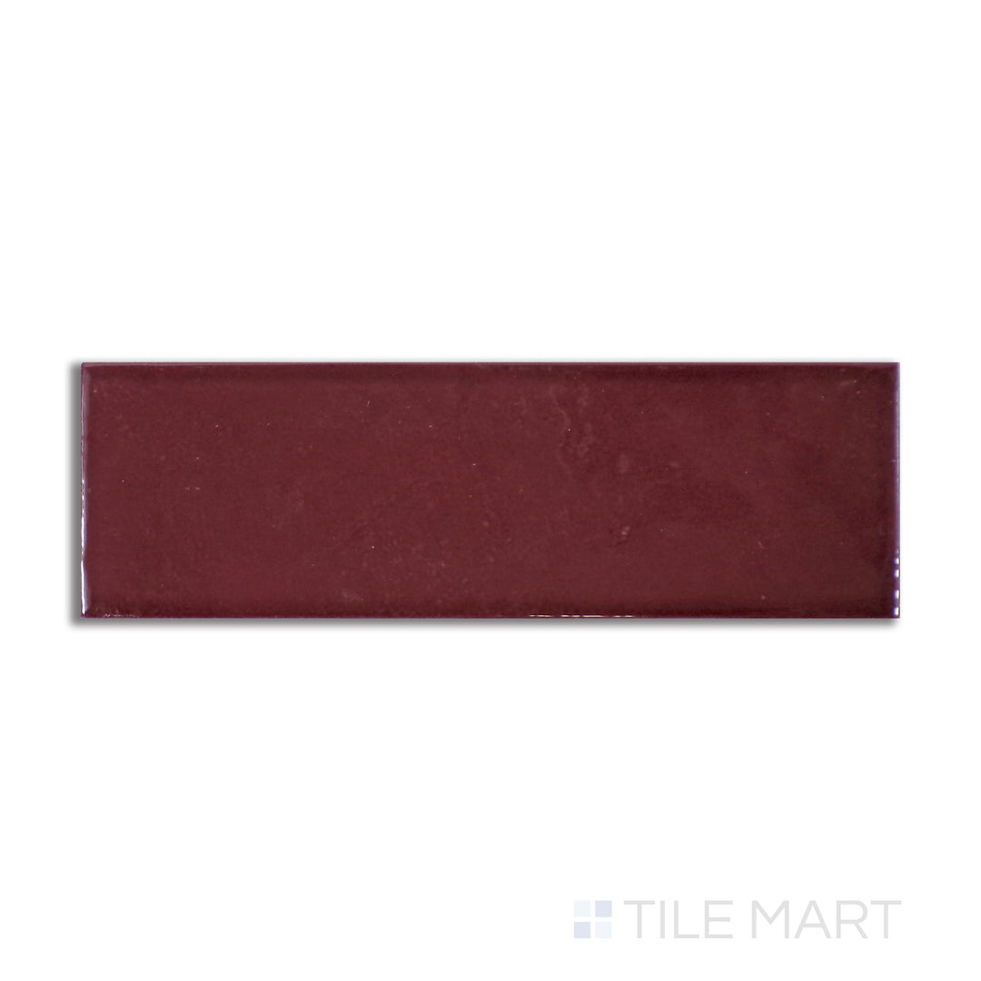 Overhead shot of Village Aubergine 2.5X8 glossy ceramic tile, a deep purple ceramic piece with a smooth, high-gloss sheen that enhances dramatic spaces.