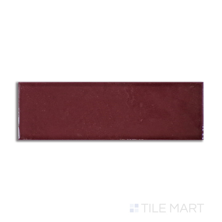 Overhead shot of Village Aubergine 2.5X8 glossy ceramic tile, a deep purple ceramic piece with a smooth, high-gloss sheen that enhances dramatic spaces.