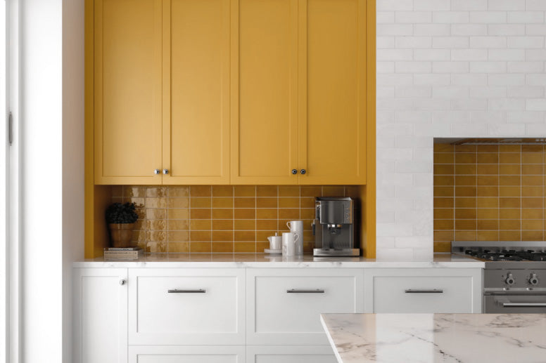 A warm and radiant interior brought to life with Village Tuscany Gold 2.5X8 Glossy Ceramic, exuding rich golden hues that add warmth and depth to the setting.