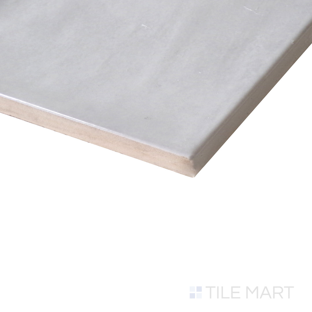 Diagonal view of Village Silver Mist 5x5 glossy ceramic tile, showcasing its soft silver-gray hue, sleek glossy texture, and structured square design.  