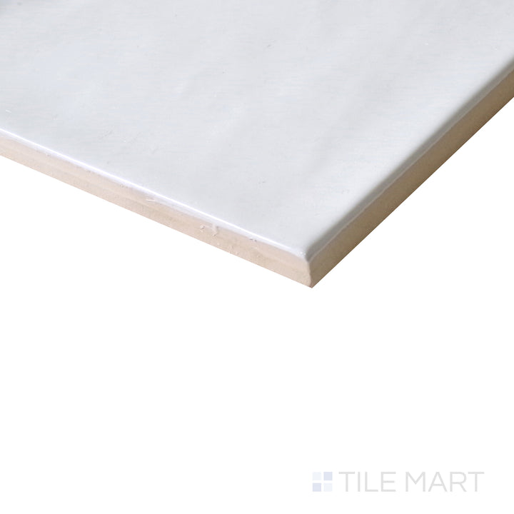 Slanted perspective of Village White 5x5 glossy ceramic tile, emphasizing its crisp white finish, reflective surface, and elegant square layout.  