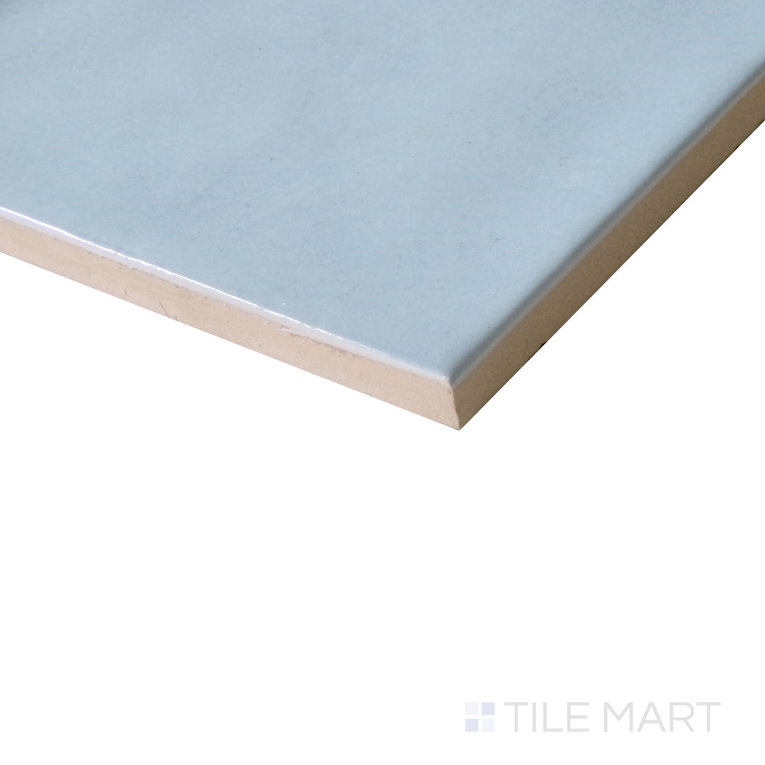 Diagonal view of Village Cloud 5x5 glossy ceramic tile, featuring a soft gray-blue tone, sleek finish, and contemporary square format.  