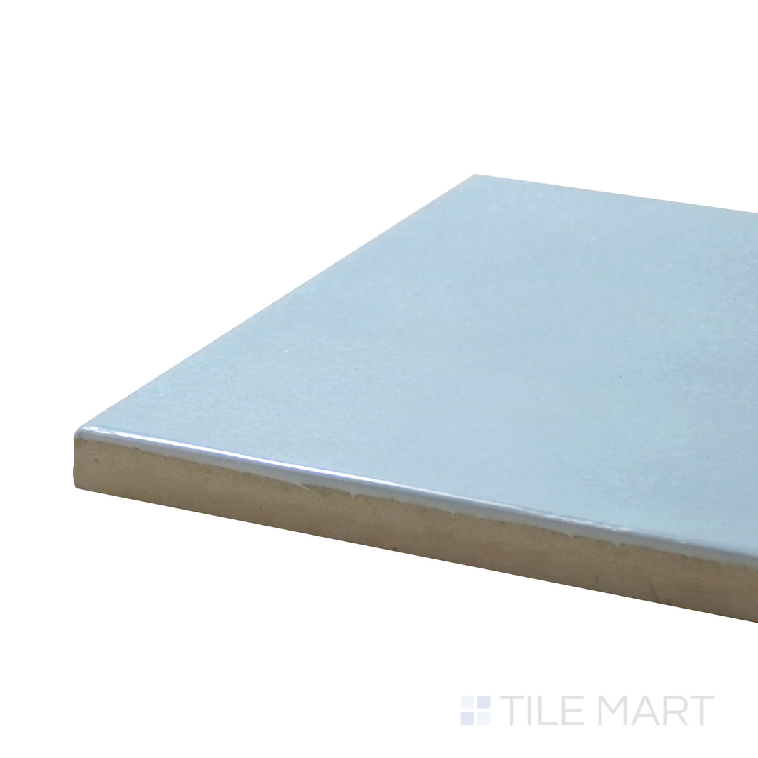 Corner-focused shot of Village Cloud 5X5 Glossy Ceramic Tile, highlighting its soft gray tones with a smooth, glass-like finish.