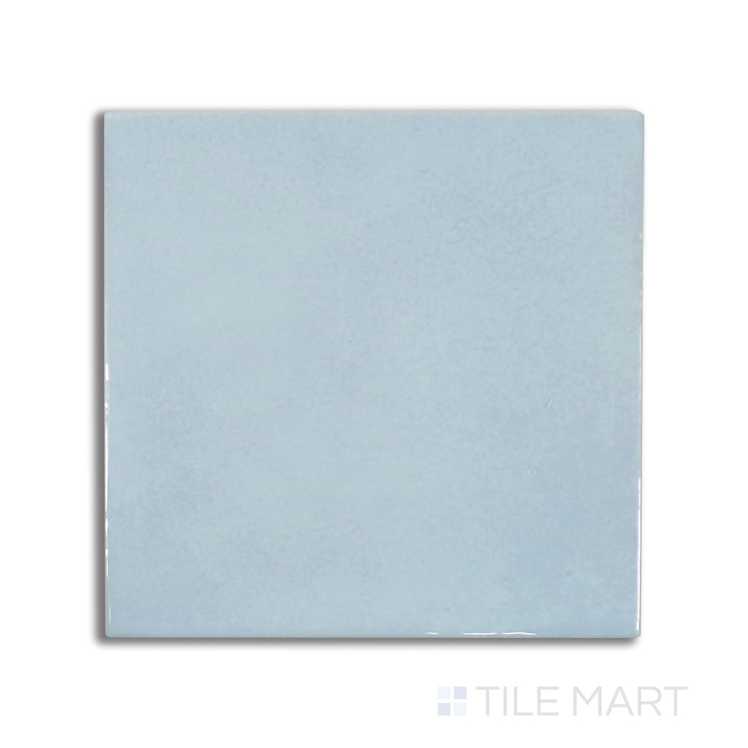 Top-down view of Village Cloud 5X5 glossy ceramic tile, a muted gray shade with a reflective glaze for a soft yet modern touch.