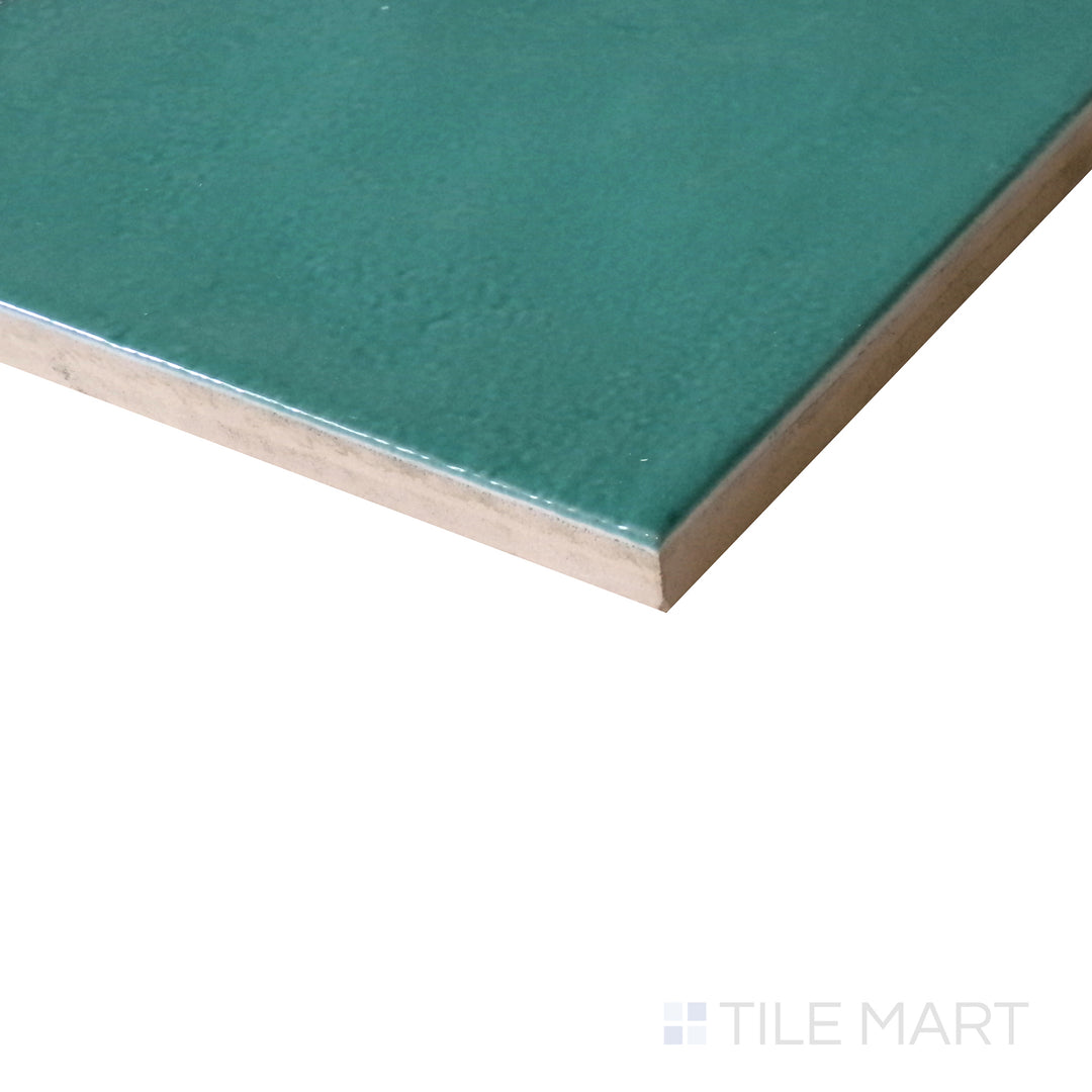 Slanted angle of Village Emerald Green 5x5 glossy ceramic tile, capturing its rich green shade, polished surface, and timeless square shape.  