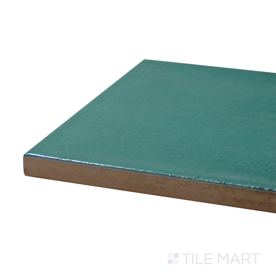 Close-up corner shot of Village Emerald Green 5X5 Glossy Ceramic Tile, featuring its deep green shade with a striking, polished surface.