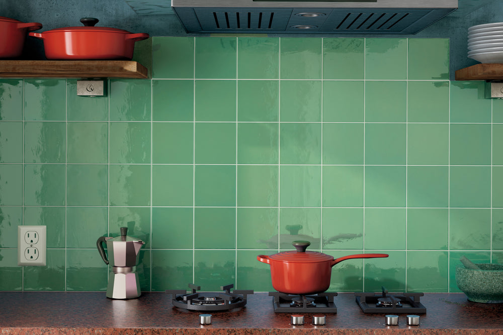 A refreshing and elegant setting featuring Village Emerald Green 5X5 Glossy Ceramic, infusing the space with a rich green hue and a luminous surface.