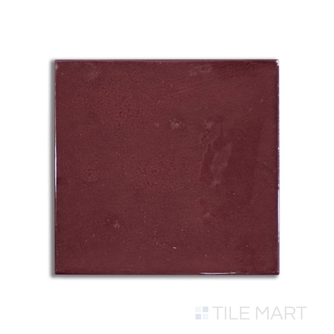 Overhead shot of Village Aubergine 5X5 glossy ceramic tile, an elegant deep purple ceramic with a reflective finish that enhances moody, sophisticated spaces.