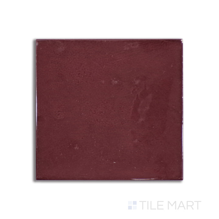 Overhead shot of Village Aubergine 5X5 glossy ceramic tile, an elegant deep purple ceramic with a reflective finish that enhances moody, sophisticated spaces.