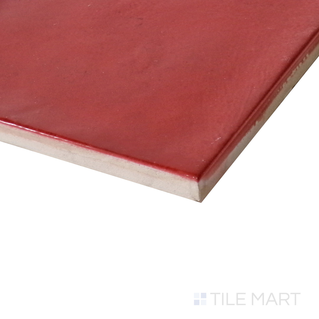 Slanted perspective of Village Volcanic Red 5x5 glossy ceramic tile, emphasizing its striking red color, glossy reflective surface, and modern square design.  