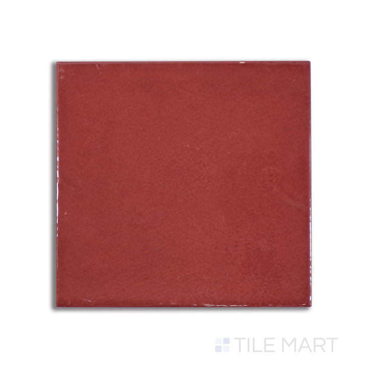 Aerial perspective of Village Volcanic Red 5X5 glossy ceramic tile, a vibrant red surface with a mirror-like shine that creates a bold statement.