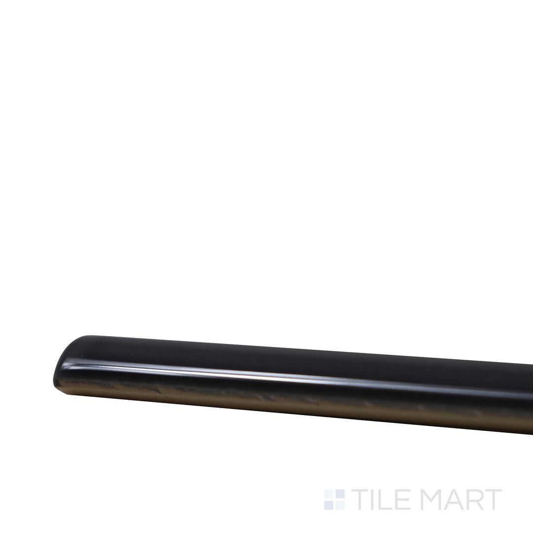 Angled close-up of Village Black 0.5X8 Glossy Ceramic Jolly, showcasing its deep black tone with a glossy, refined edge for sleek trims.