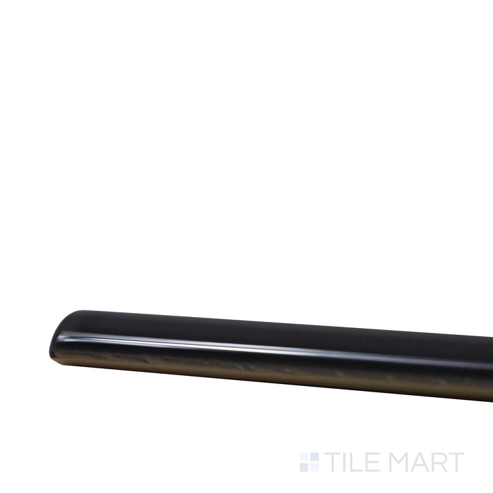 Angled close-up of Village Black 0.5X8 Glossy Ceramic Jolly, showcasing its deep black tone with a glossy, refined edge for sleek trims.