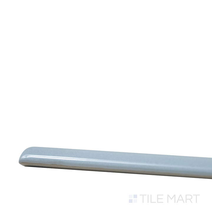 Corner-focused shot of Village Cloud 0.5X8 Glossy Ceramic Jolly, highlighting its soft gray hues with a smooth, polished finish.