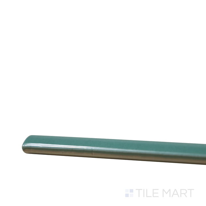 Close-up corner shot of Village Emerald Green 0.5X8 Glossy Ceramic Jolly, featuring its lush green tones with a luminous, glossy surface.
