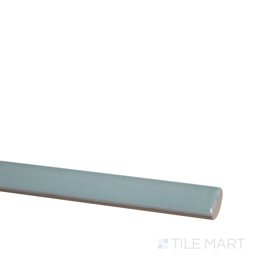 Diagonal shot of Village Mint 0.5x8 glossy ceramic jolly tile, capturing its soft mint tone, sleek surface, and refined trim application.  