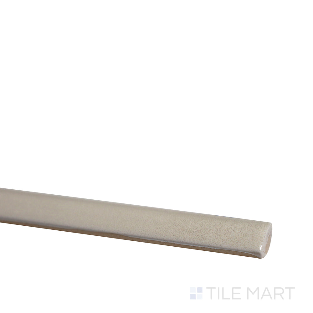 Slanted angle of Village Mushroom 0.5x8 glossy ceramic jolly tile, highlighting its warm earthy tones, smooth polished texture, and delicate trim design.  