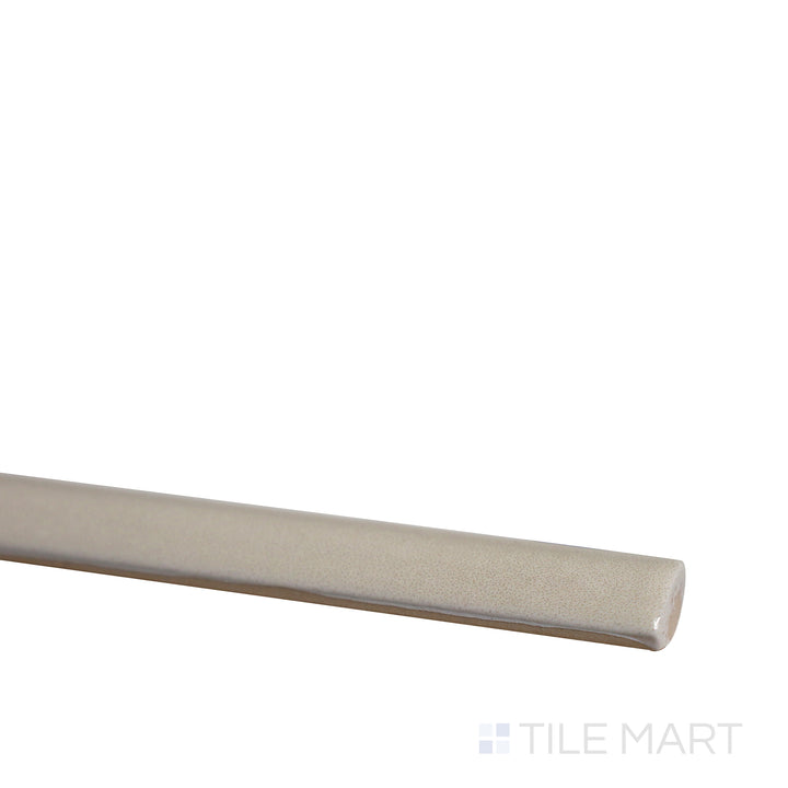 Slanted angle of Village Mushroom 0.5x8 glossy ceramic jolly tile, highlighting its warm earthy tones, smooth polished texture, and delicate trim design.  