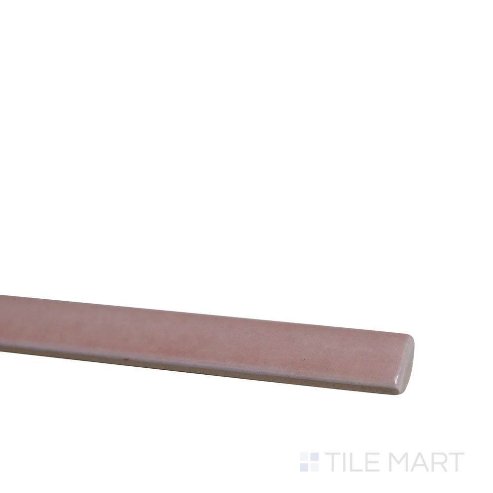 Angled shot of Village Rose Gold 0.5x8 glossy ceramic jolly tile, featuring a soft rose gold hue, shimmering glossy finish, and structured trim layout.  