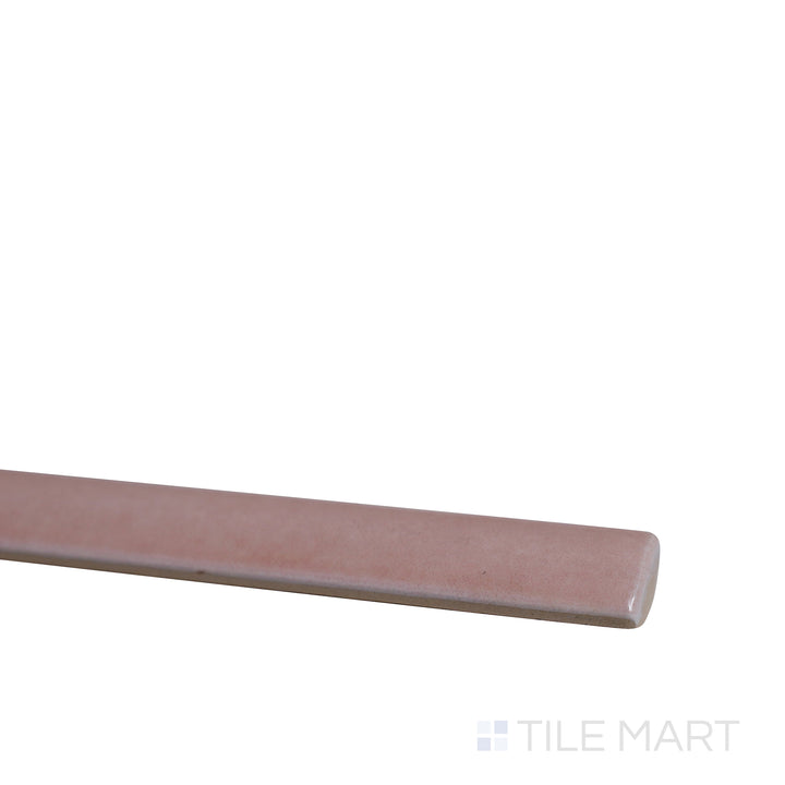 Angled shot of Village Rose Gold 0.5x8 glossy ceramic jolly tile, featuring a soft rose gold hue, shimmering glossy finish, and structured trim layout.  