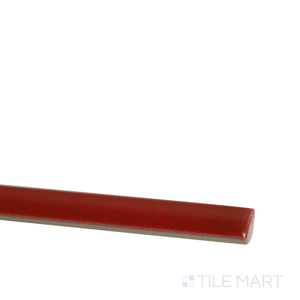 Angled shot of Village Volcanic Red 0.5x8 glossy ceramic jolly tile, featuring a bold red hue, sleek glossy finish, and refined trim design.  