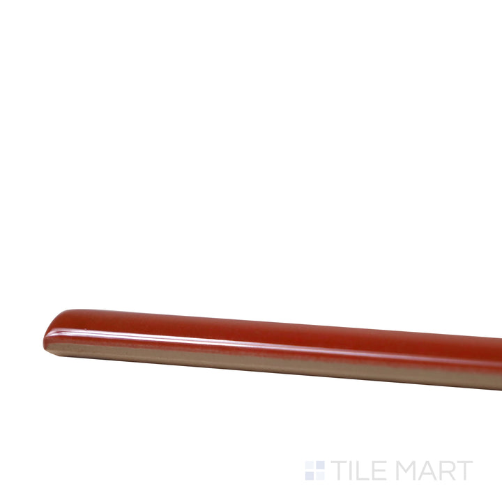 Side perspective of Village Volcanic Red 0.5X8 Glossy Ceramic Jolly, capturing its intense red tones with a sleek, polished trim.