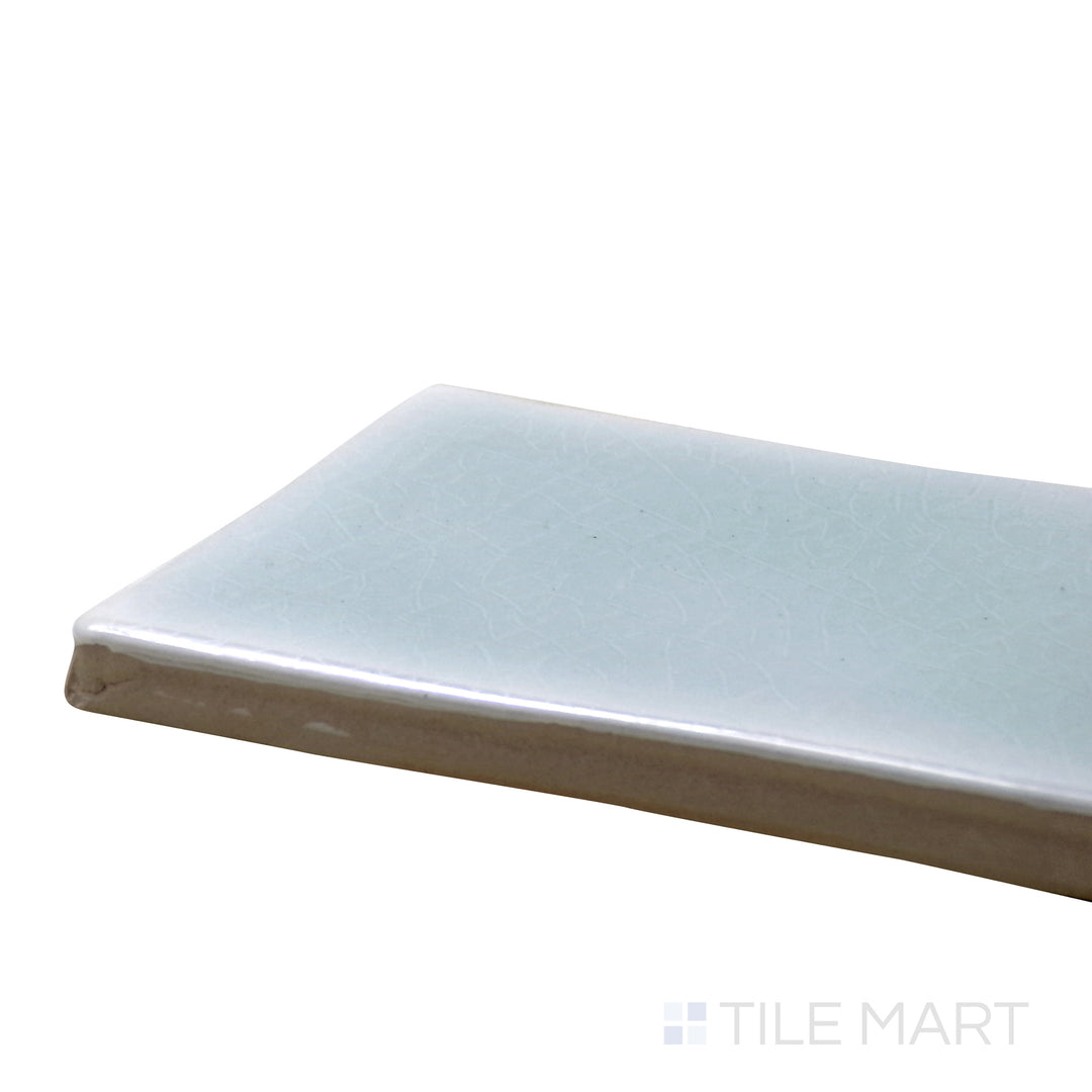 Corner shot of Vitral Aqua 3X12 Glossy Ceramic Tile, showcasing its refreshing aqua blue hue with a sleek, high-gloss finish.