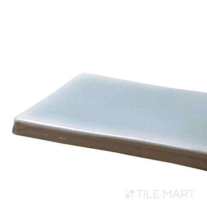 Corner shot of Vitral Aqua 3X12 Glossy Ceramic Tile, showcasing its refreshing aqua blue hue with a sleek, high-gloss finish.