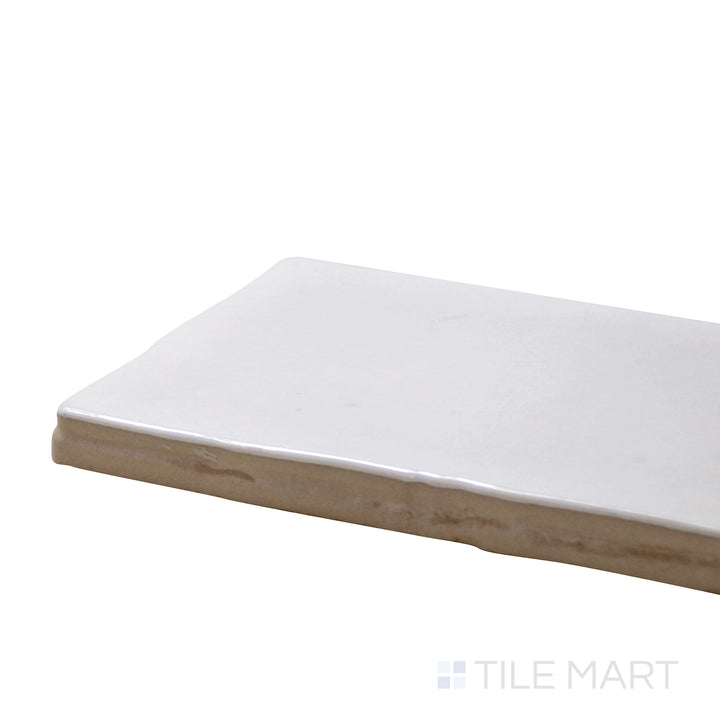 Angled view of Vitral Bianco 3X12 Glossy Ceramic Tile, highlighting its crisp white tones with a reflective, polished surface.