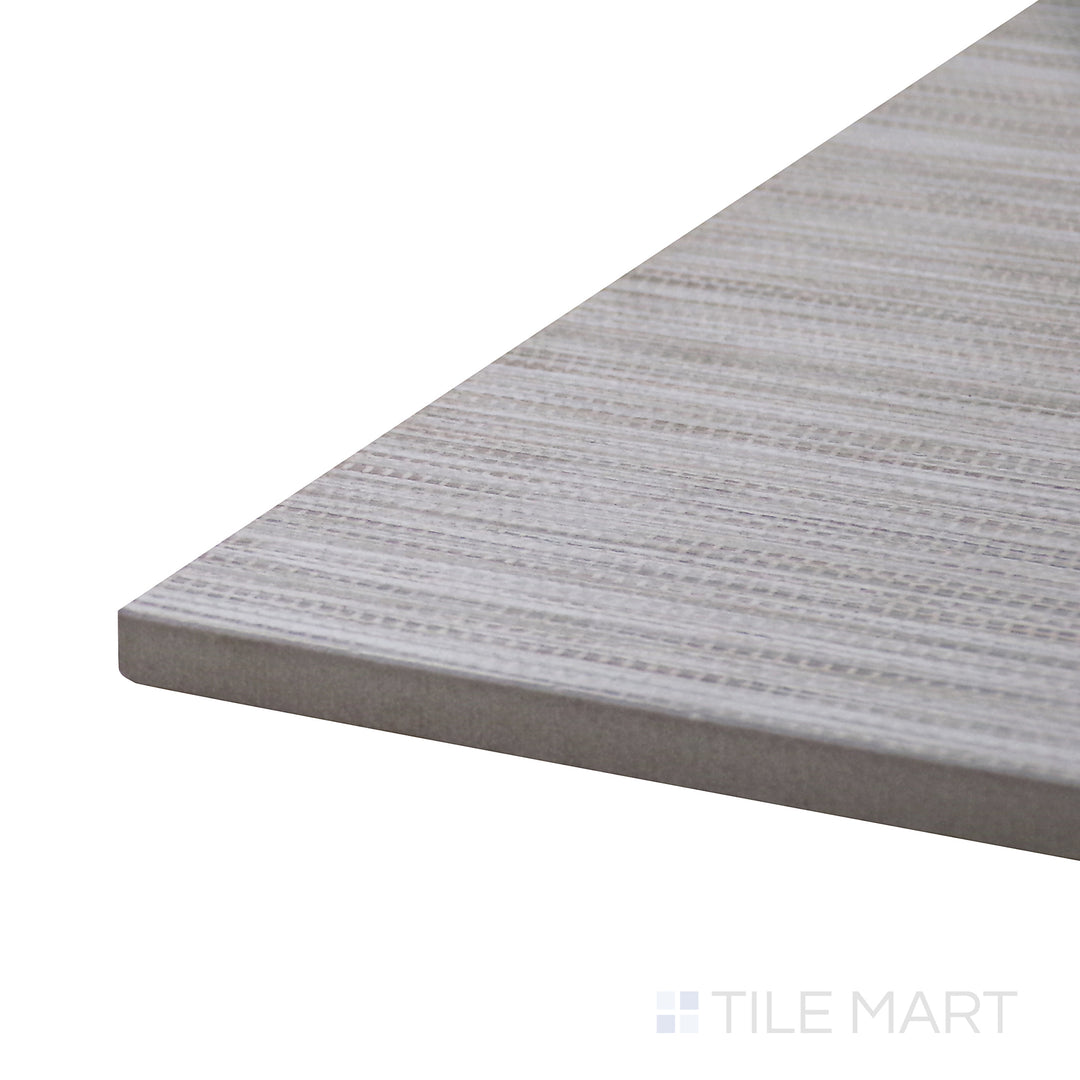 Angled view of Wooow Linen Biscuit 12X24 Matte Porcelain Tile, showcasing its warm beige linen-like texture in a smooth matte surface.